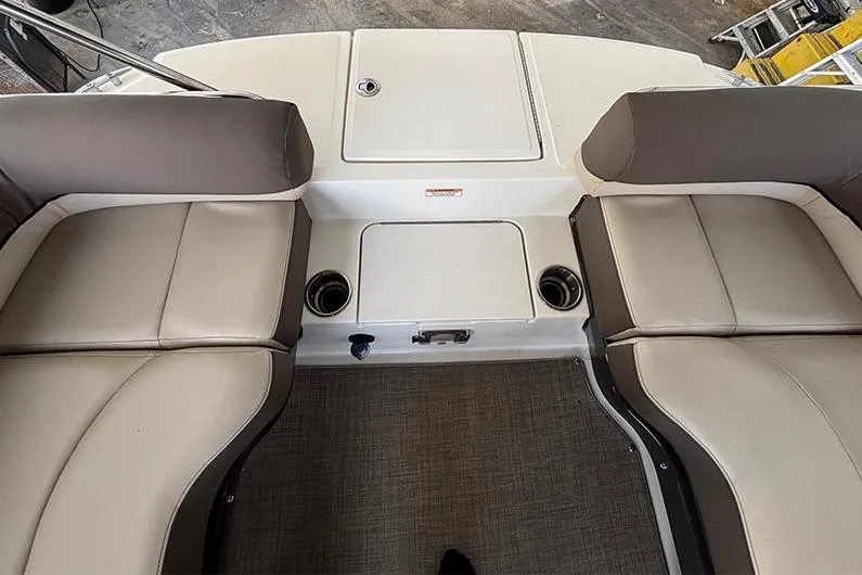 Slide: The Image of 2017 Bayliner Element XR7 boat interior with beige seating and cup holders. - 13