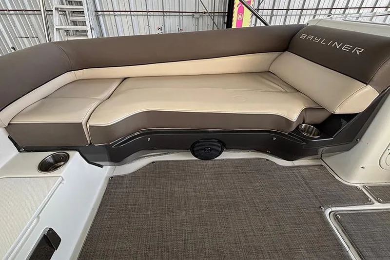 Slide: The Image of 2017 Bayliner Element XR7 boat interior with cushioned seating and cup holders. - 15
