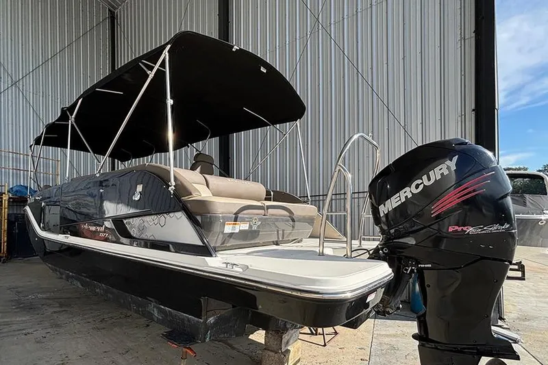 Slide: The Image of 2017 Bayliner Element XR7 boat with Mercury outboard motor in a storage facility. - 2