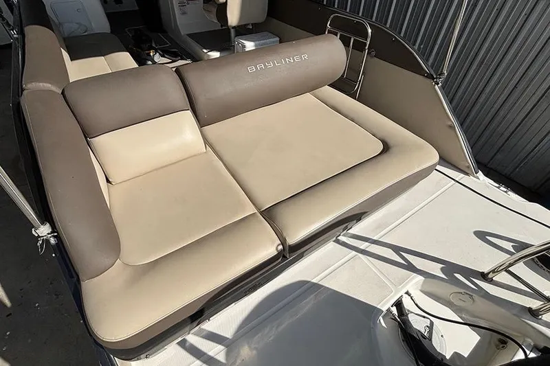 Slide: The Image of 2017 Bayliner Element XR7 boat interior with beige and brown seating. - 4