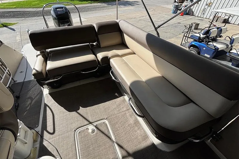 Slide: The Image of 2017 Bayliner Element XR7 boat interior with beige seating and spacious layout. - 5