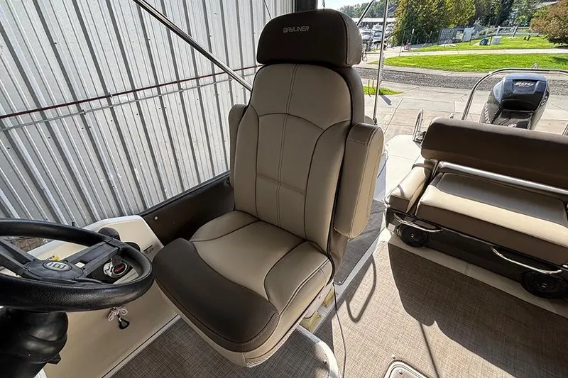 Slide: The Image of 2017 Bayliner Element XR7 boat interior with captain's chair and seating area. - 6