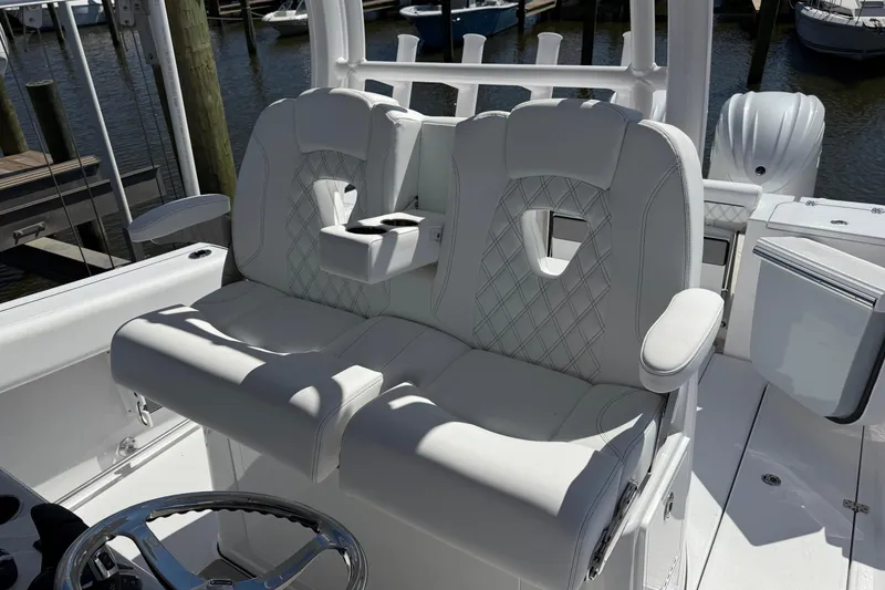 Slide: The Image of 2026 Sportsman Open 302 Center Console boat with luxurious white seating and steering wheel. - 10