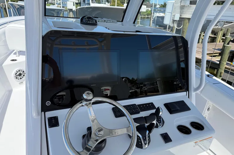 Slide: The Image of 2026 Sportsman Open 302 Center Console helm with dual displays and steering wheel. - 11