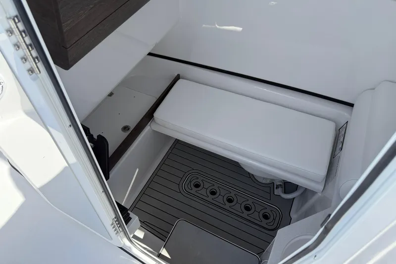 Slide: The Image of 2026 Sportsman Open 302 Center Console interior with cushioned seating and non-slip flooring. - 12