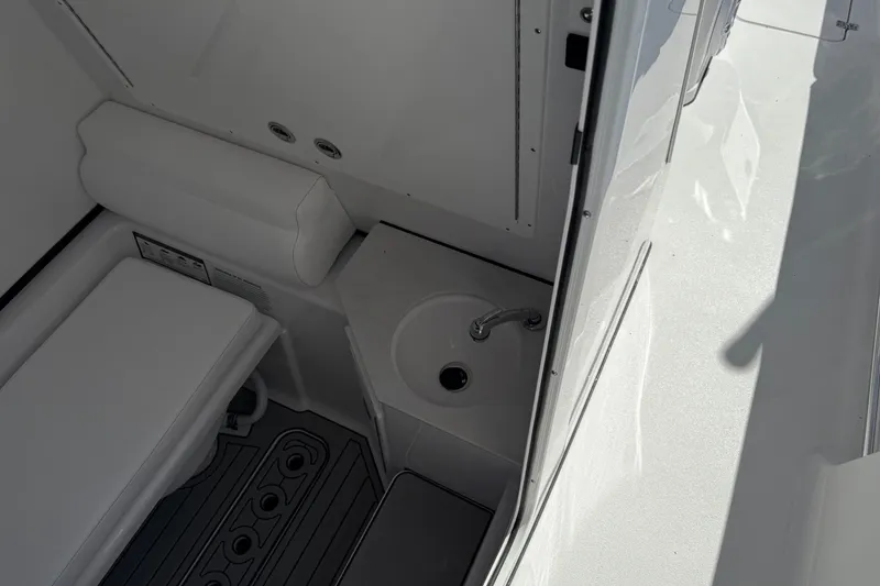Slide: The Image of Interior of 2026 Sportsman Open 302 Center Console with sink and seating. - 14