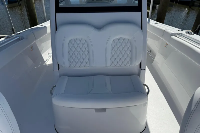 Slide: The Image of 2026 Sportsman Open 302 Center Console boat with white cushioned seating. - 15