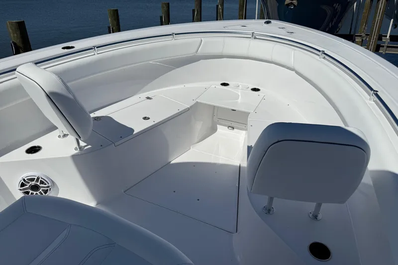 Slide: The Image of 2026 Sportsman Open 302 Center Console boat interior with white seating and storage compartments. - 18