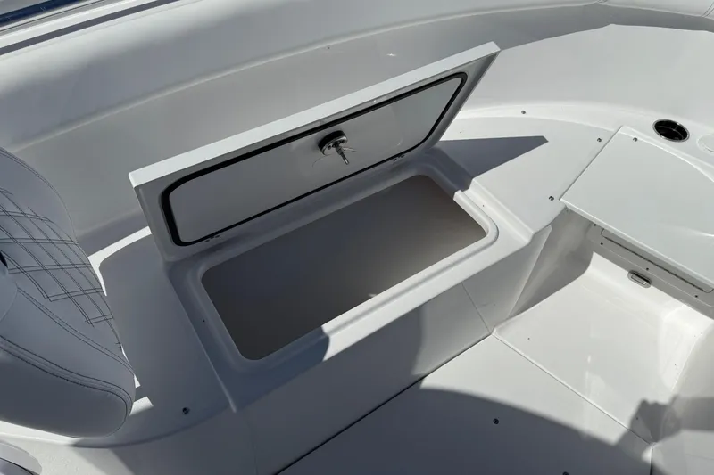 Slide: The Image of 2026 Sportsman Open 302 Center Console boat storage compartment, open with visible seating area. - 19