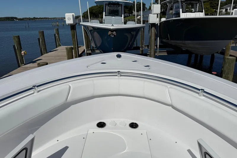 Slide: The Image of 2026 Sportsman Open 302 Center Console boat docked by the water. - 21