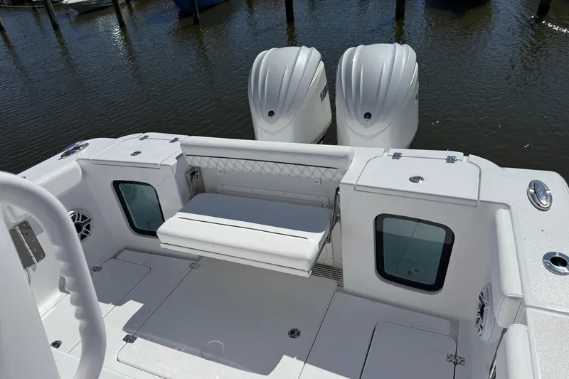 Slide: The Image of 2026 Sportsman Open 302 Center Console boat with dual engines and seating area. - 3