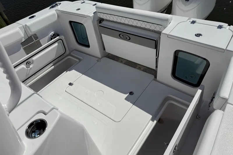 Slide: The Image of 2026 Sportsman Open 302 Center Console boat interior with storage compartments and seating. - 4