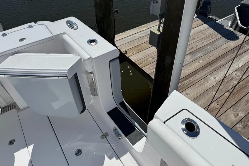 Slide: The Image of 2026 Sportsman Open 302 Center Console boat at dock, featuring open side door. - 7