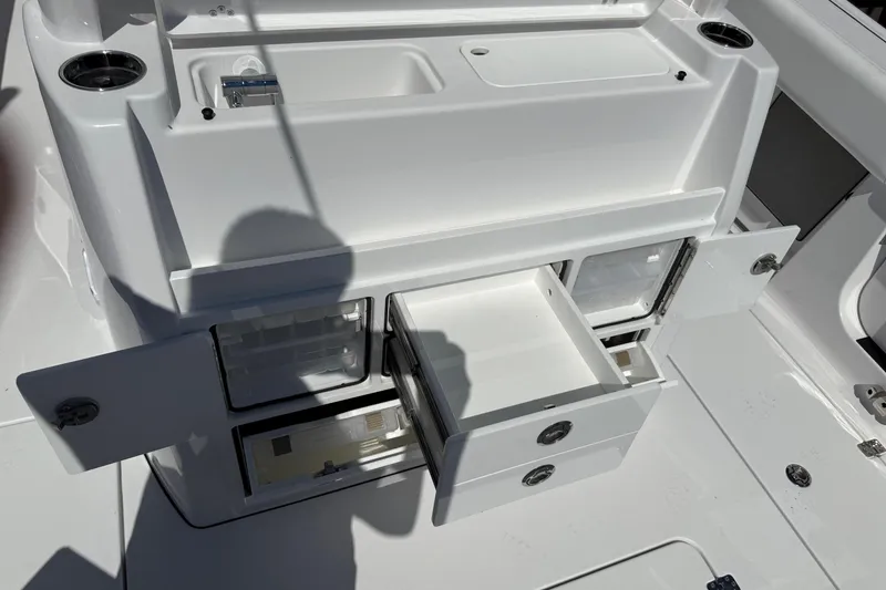 Slide: The Image of 2026 Sportsman Open 302 Center Console storage compartments with open drawers and doors. - 9