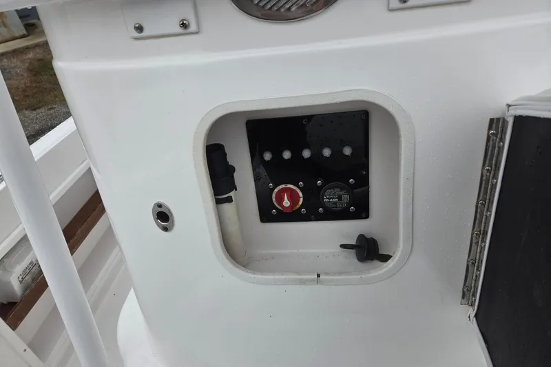 Slide: The Image of Control panel of a 2022 Limestone L200CC boat, featuring switches and a red knob. - 5