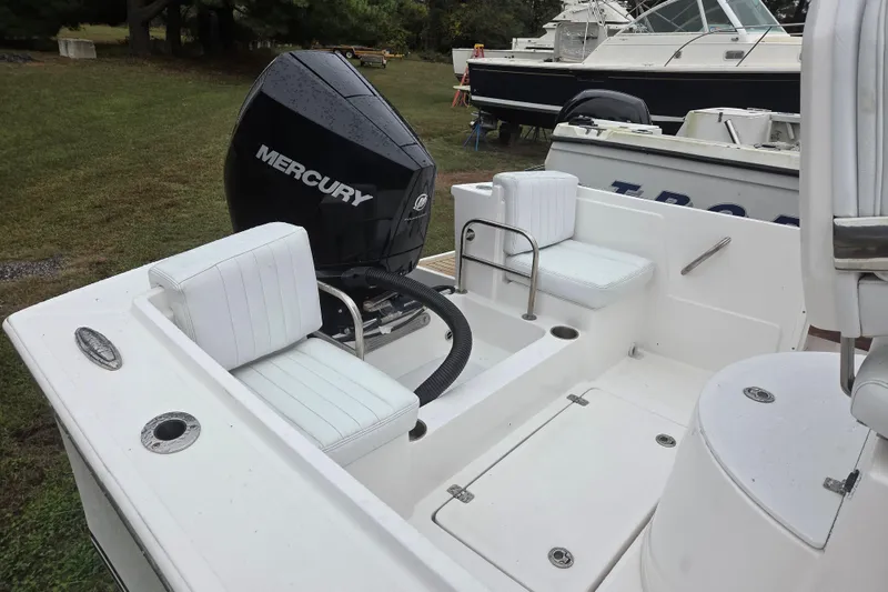 Slide: The Image of 2022 Limestone L200CC boat with Mercury outboard engine, white seating, and spacious deck. - 7