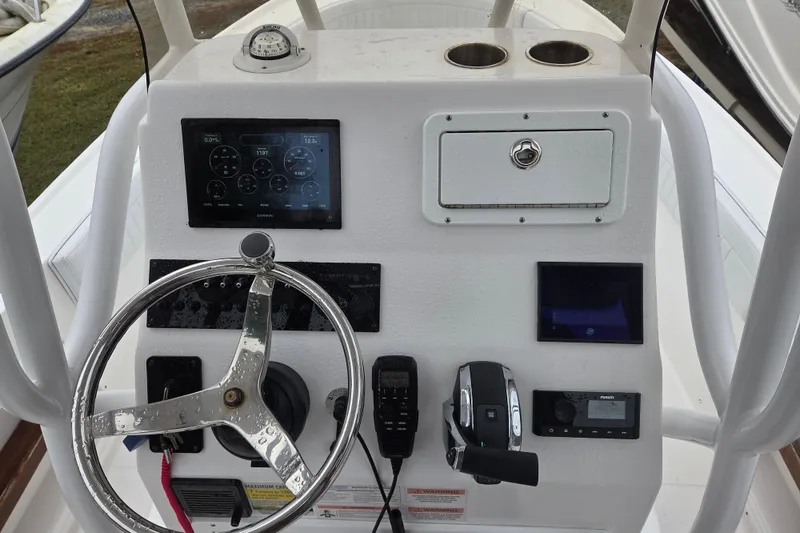 Slide: The Image of 2022 Limestone L200CC boat dashboard with steering wheel and navigation controls. - 8