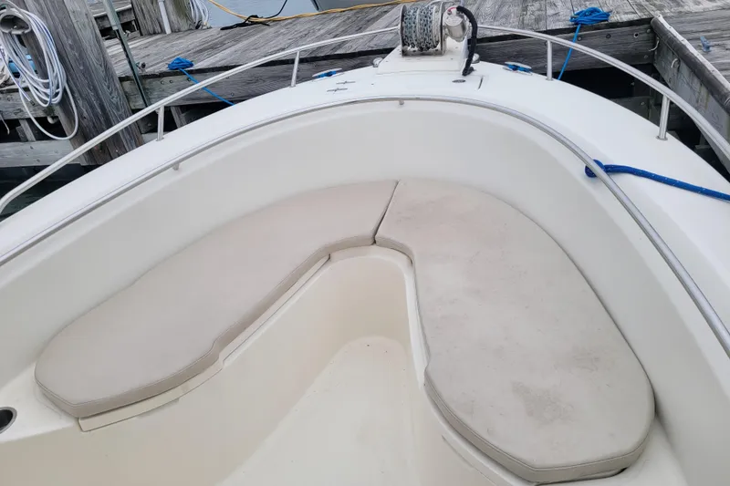 Slide: The Image of 2008 Pursuit C 250 Center Console boat with cushioned seating at dock. - 10