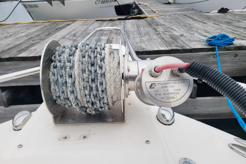 Slide: The Image of Winch motor and chain on 2008 Pursuit C 250 Center Console boat at dock. - 11