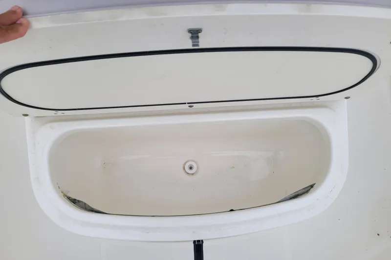Slide: The Image of Open storage compartment on 2008 Pursuit C 250 Center Console boat. - 15