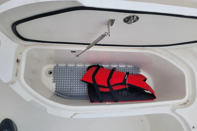 Slide: The Image of Storage compartment of 2008 Pursuit C 250 Center Console with red life jacket. - 17