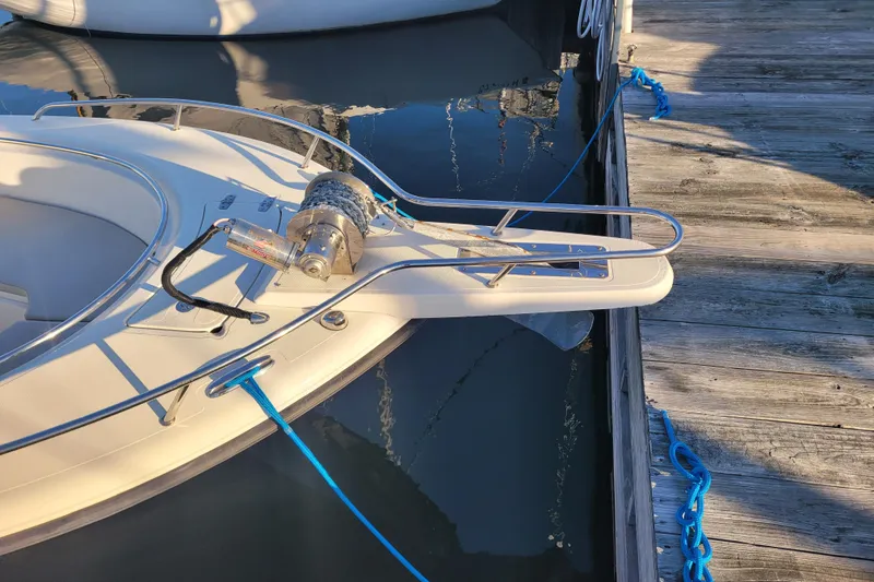 Slide: The Image of 2008 Pursuit C 250 Center Console boat docked with blue ropes. - 3