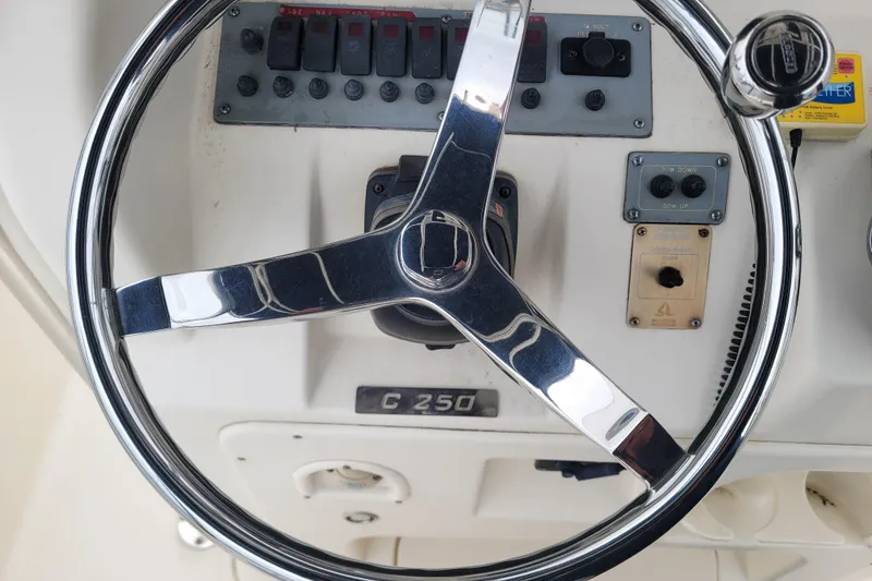 Slide: The Image of Steering wheel of 2008 Pursuit C 250 Center Console boat with control panel. - 6