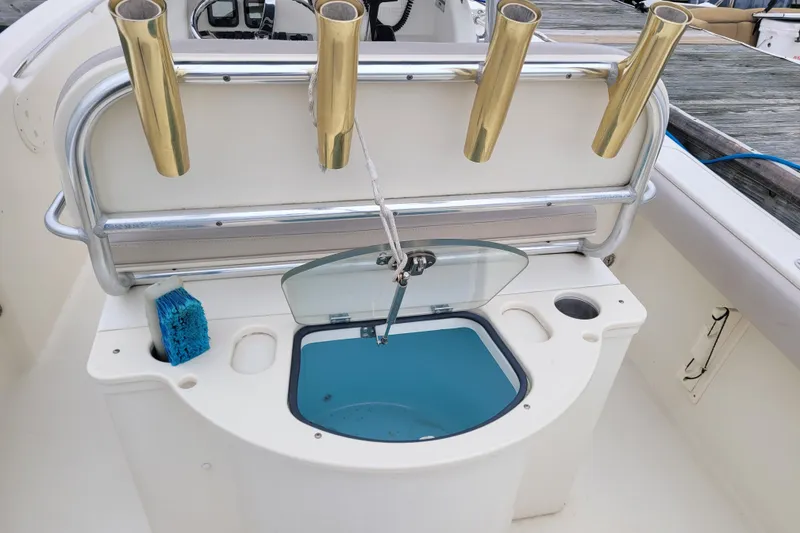 Slide: The Image of 2008 Pursuit C 250 Center Console boat with rod holders and livewell. - 9