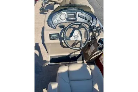 Slide: The Image of 2023 Sun Tracker Fishin' Barge 20 DLX dashboard with steering wheel and controls. - 5