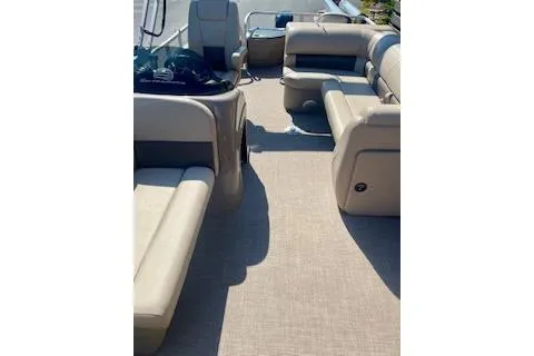 Slide: The Image of 2023 Sun Tracker Fishin' Barge 20 DLX interior with beige seating and spacious layout. - 6