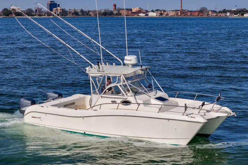 Slide: The Image of 2000 World Cat 266 SC motorboat cruising on water. - 24