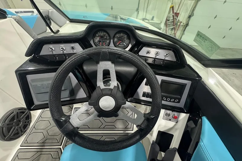 Slide: The Image of 2020 MasterCraft NXT22 dashboard with steering wheel, gauges, and control panel. - 10