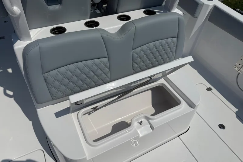 Slide: The Image of 2026 Sportsman Heritage 321 Center Console boat seat with storage compartment open. - 11