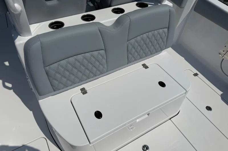 Slide: The Image of 2026 Sportsman Heritage 321 Center Console boat seat with diamond-patterned upholstery and cup holders. - 12