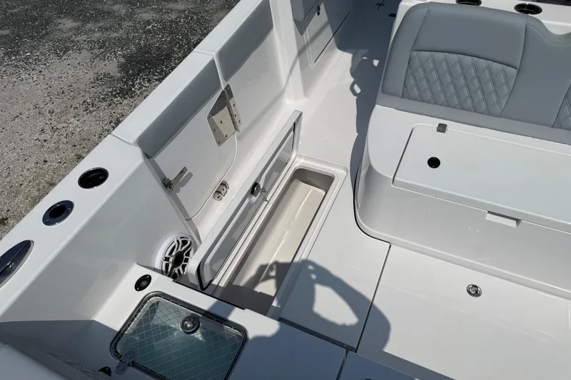 Slide: The Image of 2026 Sportsman Heritage 321 Center Console boat interior with storage compartments and seating. - 15