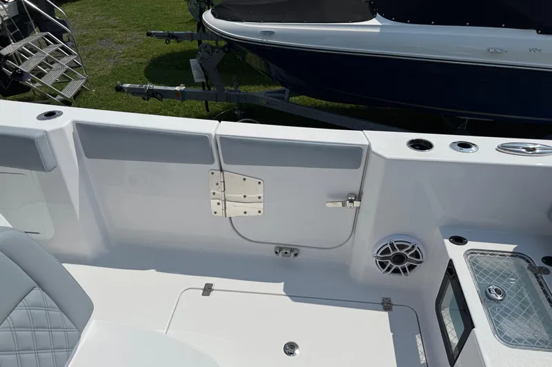 Slide: The Image of 2026 Sportsman Heritage 321 Center Console boat interior with seating and storage features. - 17