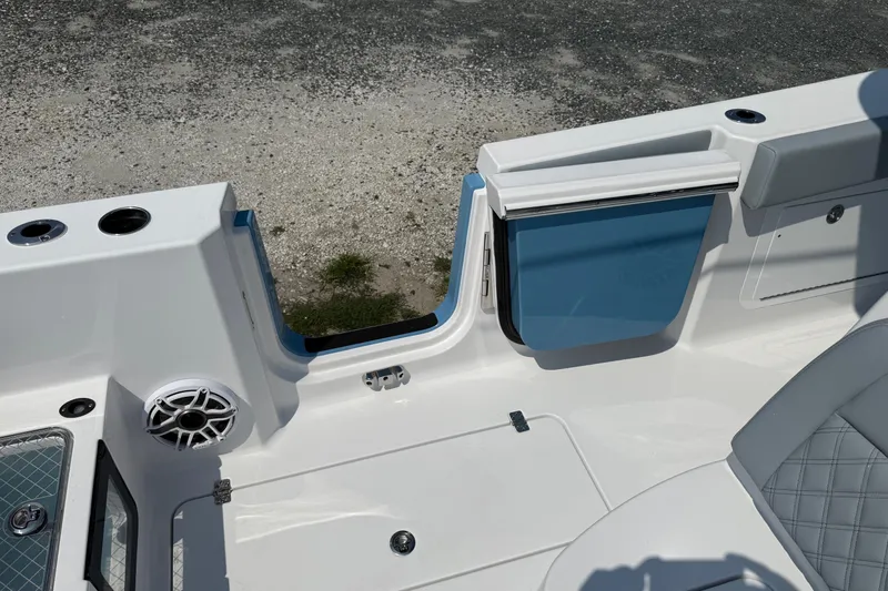 Slide: The Image of 2026 Sportsman Heritage 321 Center Console boat interior with speaker and storage compartment. - 18