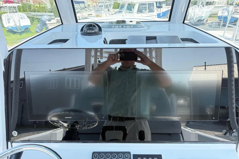 Slide: The Image of 2026 Sportsman Heritage 321 Center Console dashboard with dual Garmin displays and compass. - 23