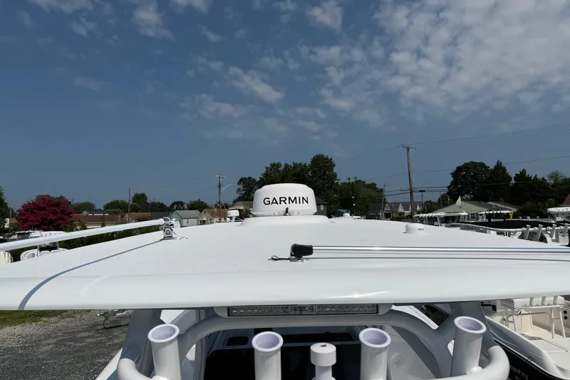 Slide: The Image of 2026 Sportsman Heritage 321 Center Console with Garmin radar, under a partly cloudy sky. - 25