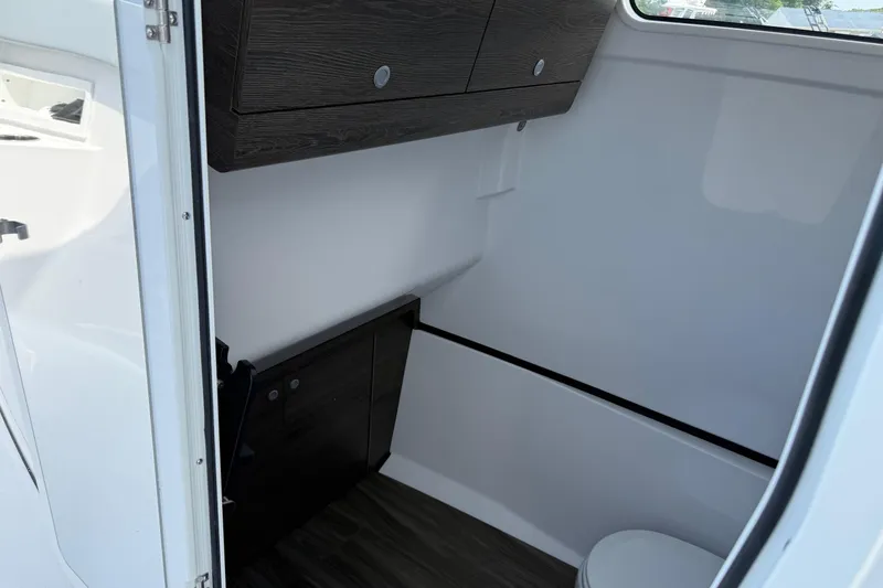 Slide: The Image of Interior of 2026 Sportsman Heritage 321 Center Console boat, featuring sleek cabinetry and compact design. - 26