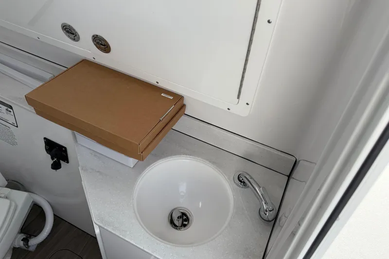 Slide: The Image of 2026 Sportsman Heritage 321 Center Console interior with sink and cardboard box. - 28