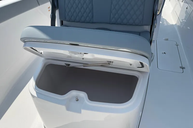 Slide: The Image of Open storage compartment on 2026 Sportsman Heritage 321 Center Console boat with cushioned seating. - 30