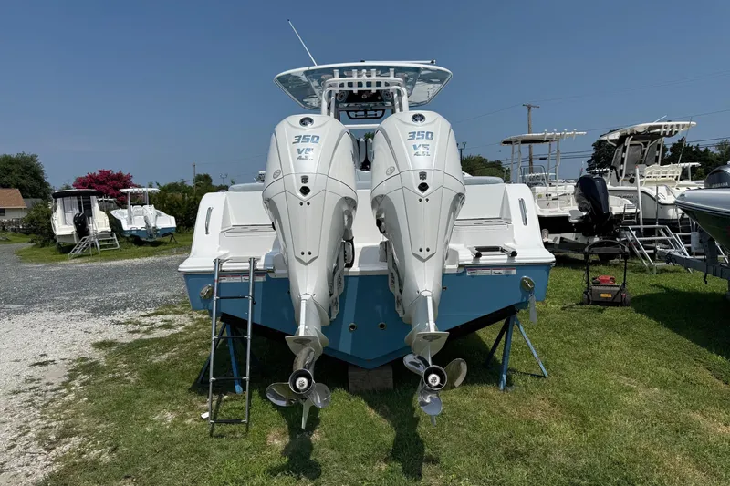 Slide: The Image of 2026 Sportsman Heritage 321 Center Console with twin 350 engines on display outdoors. - 4