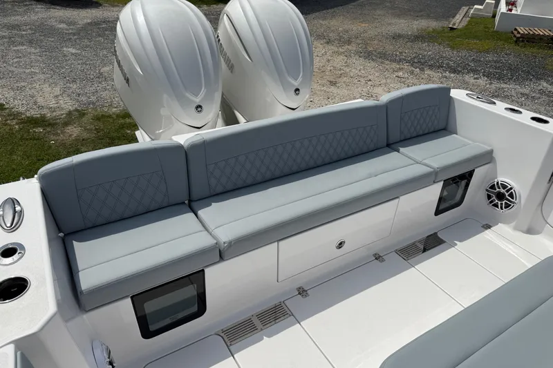 Slide: The Image of 2026 Sportsman Heritage 321 Center Console boat with dual engines and cushioned seating. - 6