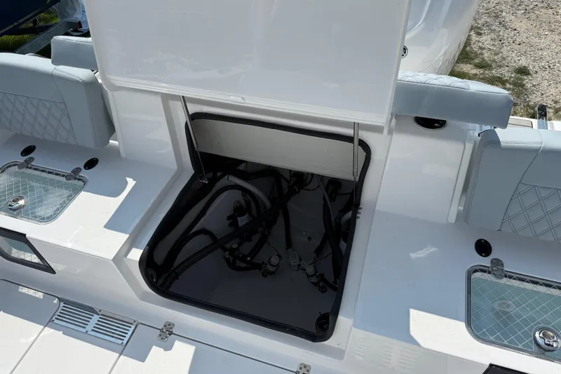 Slide: The Image of 2026 Sportsman Heritage 321 Center Console boat with open storage compartment and seating. - 8