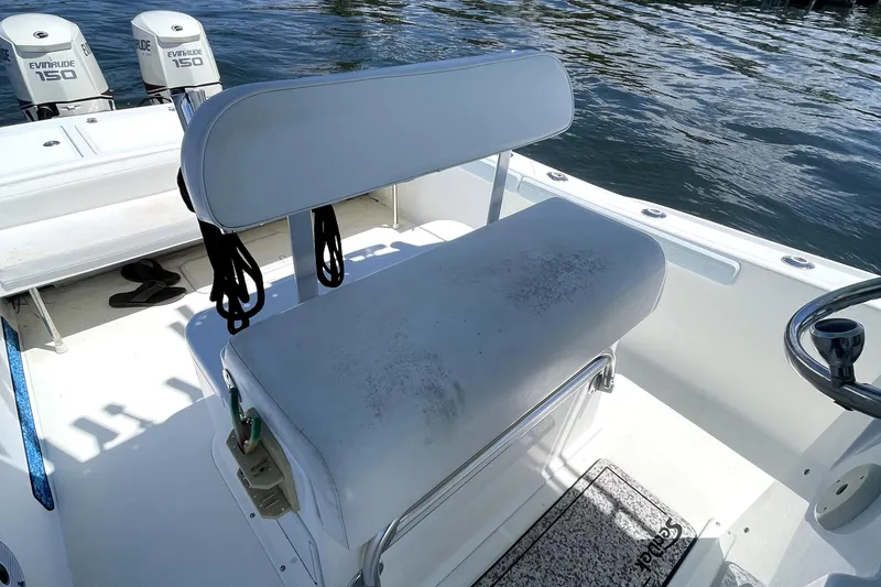 Slide: The Image of 2013 Ocean Master 27 Center Console boat interior with seating and Evinrude engines. - 10