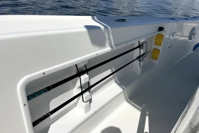 Slide: The Image of 2013 Ocean Master 27 Center Console boat with rod holders and electrical outlets. - 14
