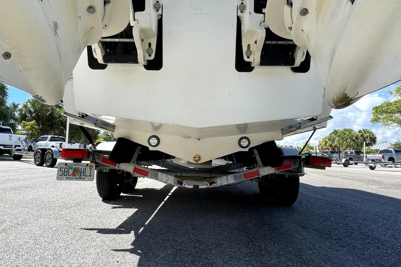 Slide: The Image of 2013 Ocean Master 27 Center Console boat on trailer, rear view in parking lot. - 3