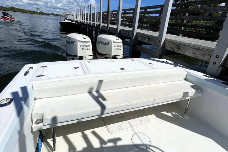 Slide: The Image of 2013 Ocean Master 27 Center Console boat with twin Evinrude 150 engines docked by a pier. - 5
