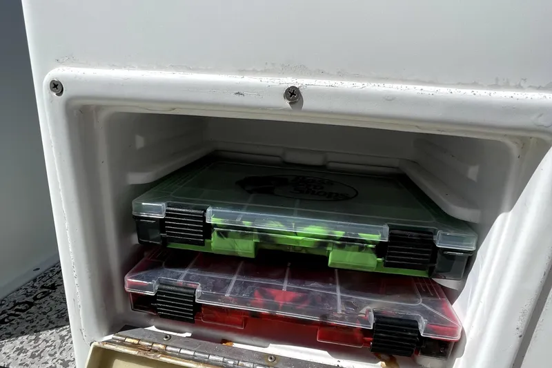Slide: The Image of Storage compartment with tackle boxes on a 2013 Ocean Master 27 Center Console boat. - 8